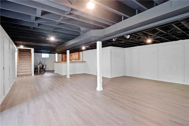 basement featuring stairs and wood finished floors