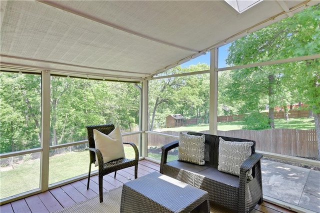 sunroom / solarium with lofted ceiling and view of scattered trees