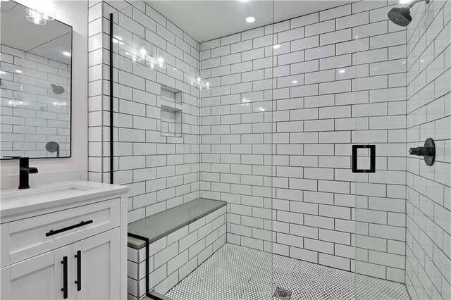 full bathroom featuring a stall shower and vanity