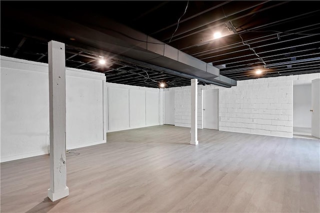 finished below grade area featuring wood finished floors