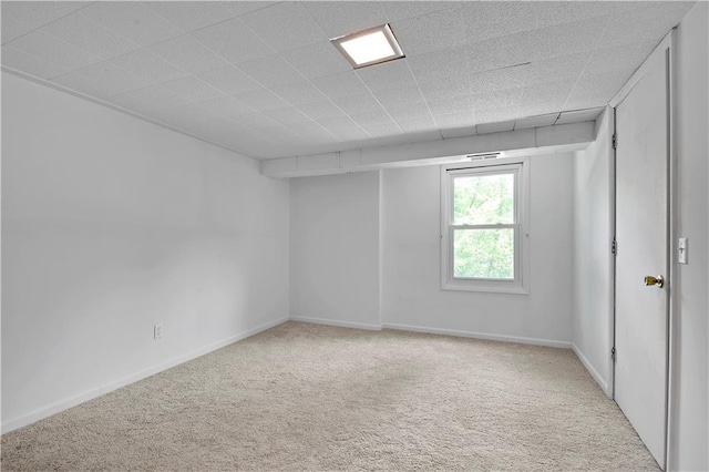 carpeted spare room with baseboards
