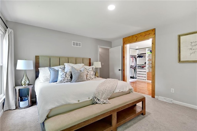bedroom with carpet floors, baseboards, a spacious closet, recessed lighting, and a closet