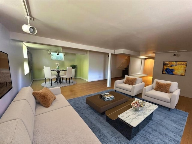 4714 Norton Ave, Kansas City, MO 64130 - living area with wood finished floors, rail lighting, and stairs