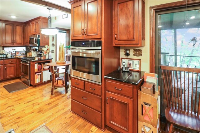 12 Woodland Trl, Warrensburg, MO 64093 - kitchen featuring stainless steel appliances, light wood-style floors, brown cabinets, and hanging light fixtures