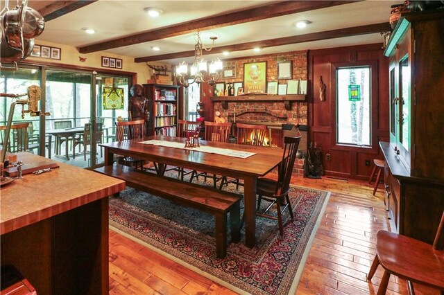 12 Woodland Trl, Warrensburg, MO 64093 - dining area featuring a chandelier, beam ceiling, and light wood finished floors