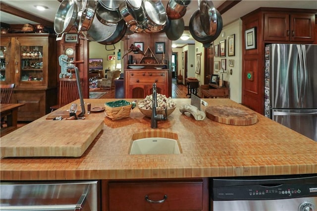 12 Woodland Trl, Warrensburg, MO 64093 - kitchen with stainless steel appliances, wooden counters, a kitchen island with sink, and a sink