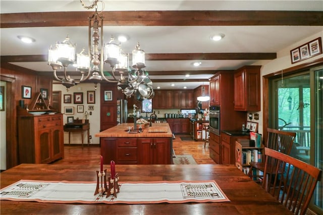 12 Woodland Trl, Warrensburg, MO 64093 - dining area featuring a chandelier, wood finished floors, beamed ceiling, and recessed lighting