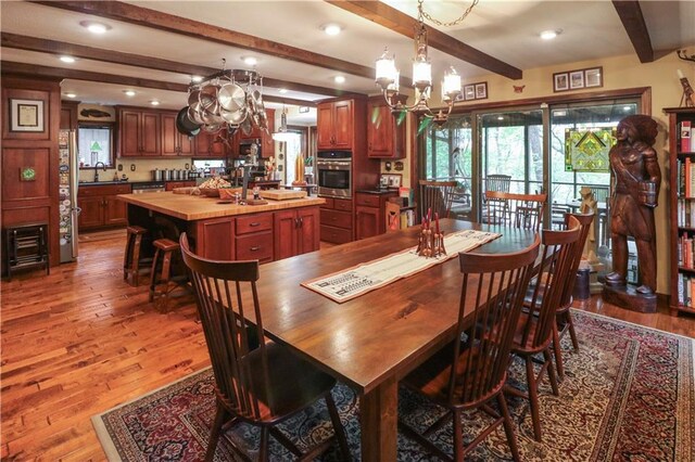 12 Woodland Trl, Warrensburg, MO 64093 - dining room with a chandelier, wood finished floors, beamed ceiling, and recessed lighting