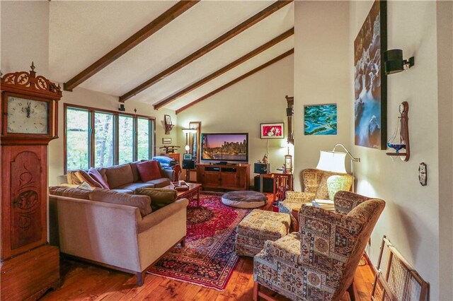 12 Woodland Trl, Warrensburg, MO 64093 - living area with beam ceiling, wood finished floors, and high vaulted ceiling