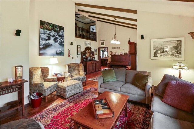 12 Woodland Trl, Warrensburg, MO 64093 - living room with beam ceiling, wood finished floors, a chandelier, and high vaulted ceiling