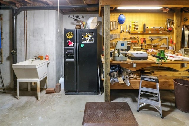 12 Woodland Trl, Warrensburg, MO 64093 - unfinished below grade area featuring a workshop area and black fridge