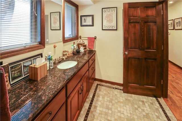 12 Woodland Trl, Warrensburg, MO 64093 - bathroom featuring vanity, baseboards, and inlaid floor details