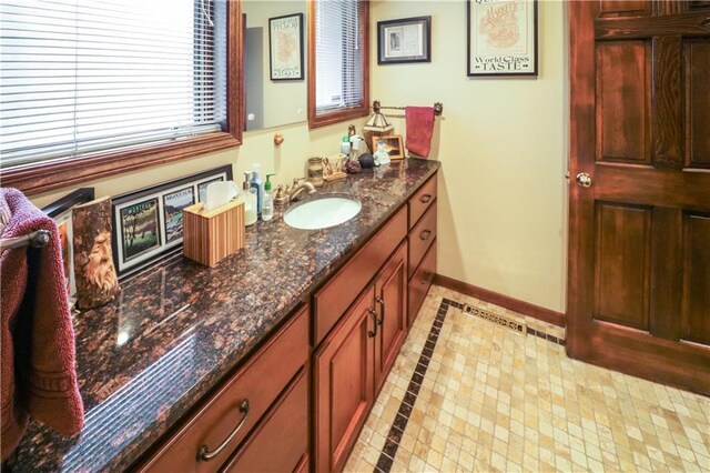 12 Woodland Trl, Warrensburg, MO 64093 - bathroom with vanity, baseboards, and inlaid floor details