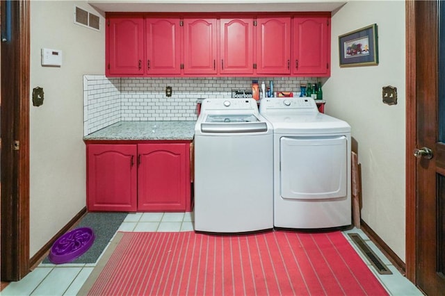 12 Woodland Trl, Warrensburg, MO 64093 - laundry area featuring cabinet space, washing machine and dryer, baseboards, and light tile patterned floors