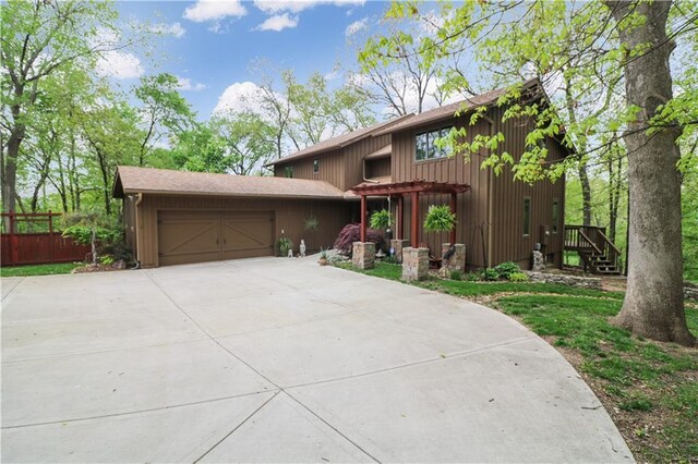 12 Woodland Trl, Warrensburg, MO 64093 - view of front of house with an attached garage and driveway