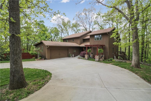 12 Woodland Trl, Warrensburg, MO 64093 - view of front facade with an attached garage and driveway