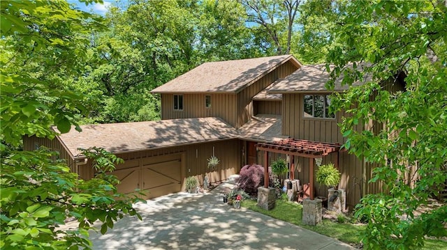 12 Woodland Trl, Warrensburg, MO 64093 - view of front of house featuring a garage, driveway, and a shingled roof