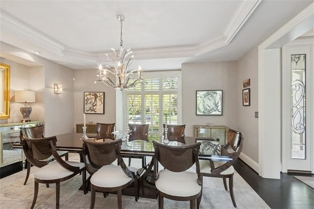 1901 Stratford Rd, Mission Hills, KS 66208 - dining space featuring a tray ceiling, a chandelier, wood finished floors, ornamental molding, and baseboards