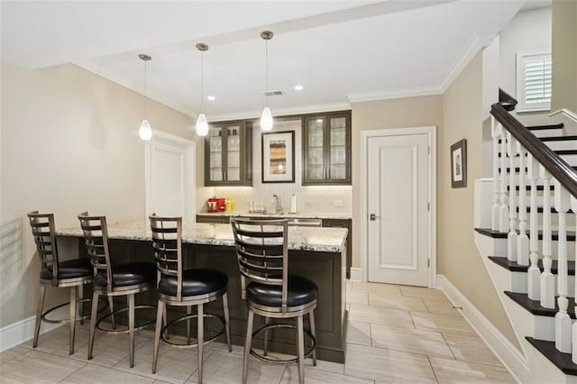 1901 Stratford Rd, Mission Hills, KS 66208 - indoor wet bar with stairway, tasteful backsplash, ornamental molding, baseboards, and decorative light fixtures