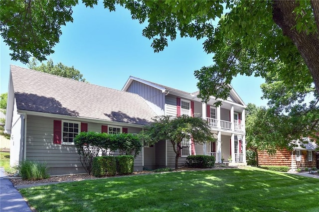 12012 Ensley Ln, Leawood, KS 66209 - view of front of property featuring a porch, a front yard, and a balcony