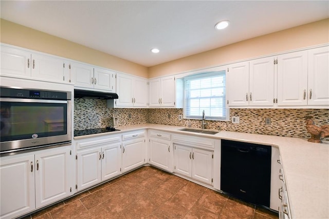12012 Ensley Ln, Leawood, KS 66209 - kitchen featuring black appliances, a sink, under cabinet range hood, tasteful backsplash, and light countertops