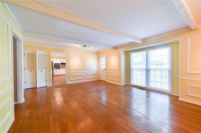 12012 Ensley Ln, Leawood, KS 66209 - unfurnished living room with beam ceiling, wood finished floors, a chandelier, a decorative wall, and ornamental molding
