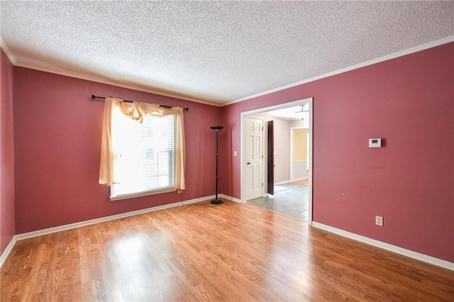 12012 Ensley Ln, Leawood, KS 66209 - unfurnished room featuring a textured ceiling, wood finished floors, crown molding, and baseboards