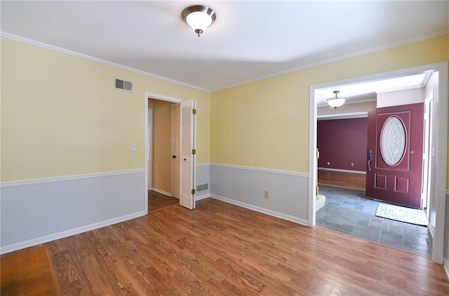 12012 Ensley Ln, Leawood, KS 66209 - empty room featuring crown molding, wood finished floors, and baseboards