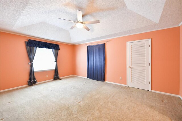 12012 Ensley Ln, Leawood, KS 66209 - carpeted empty room featuring ceiling fan, a textured ceiling, a tray ceiling, baseboards, and vaulted ceiling