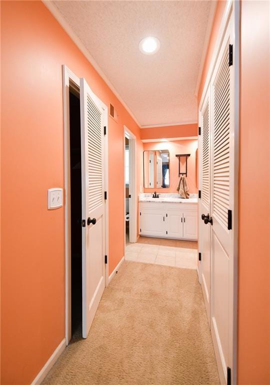12012 Ensley Ln, Leawood, KS 66209 - corridor with light carpet, baseboards, recessed lighting, light tile patterned floors, and ornamental molding