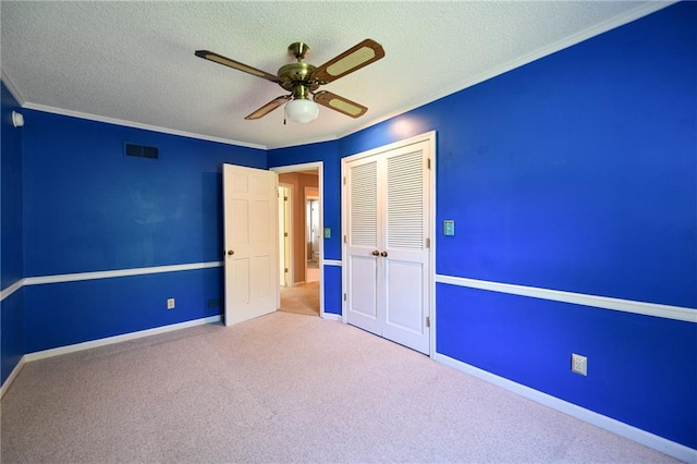 12012 Ensley Ln, Leawood, KS 66209 - unfurnished bedroom featuring a closet, a textured ceiling, carpet, crown molding, and baseboards
