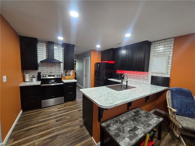 1824 S Grand Ave, Sedalia, MO 65301 - kitchen featuring wall chimney range hood, a sink, light countertops, electric stove, and freestanding refrigerator