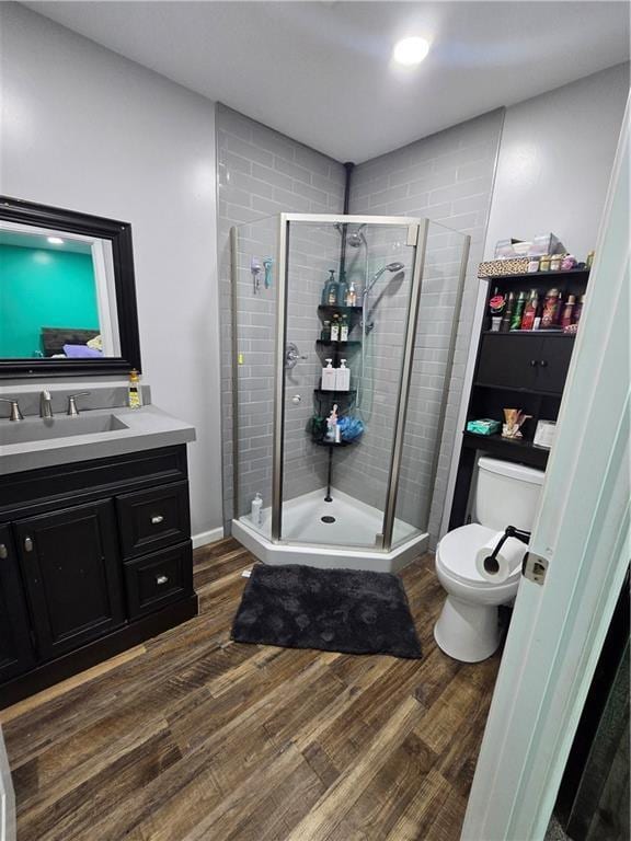 1824 S Grand Ave, Sedalia, MO 65301 - full bathroom with vanity, a stall shower, and wood finished floors