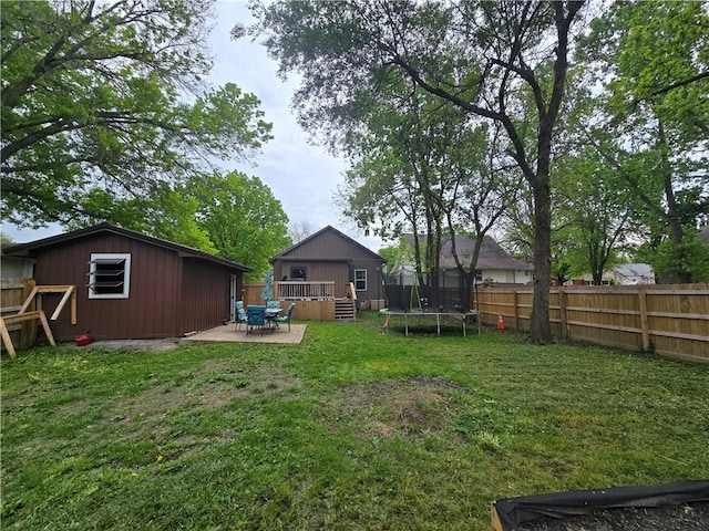 1824 S Grand Ave, Sedalia, MO 65301 - view of yard with a fenced backyard, a trampoline, a patio area, and a wooden deck