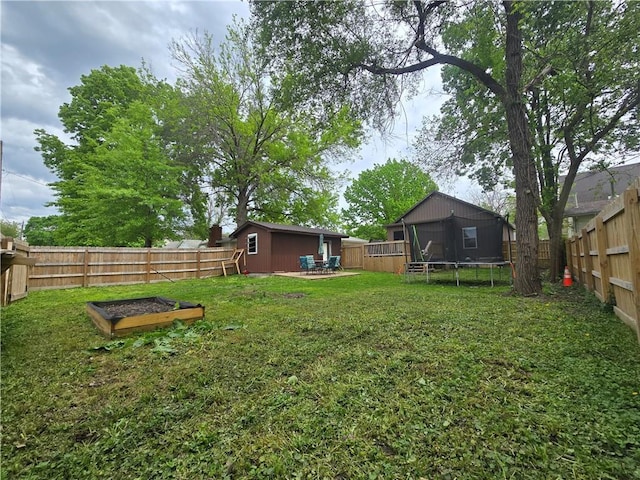1824 S Grand Ave, Sedalia, MO 65301 - view of yard featuring a fenced backyard, a trampoline, and a vegetable garden