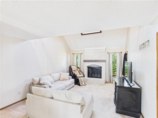 carpeted living area featuring vaulted ceiling, attic access, a textured ceiling, a brick fireplace, and baseboards