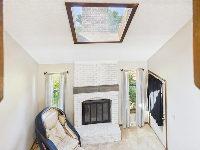 carpeted living area with a fireplace and baseboards