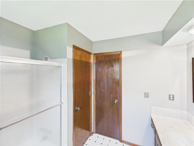 bathroom with a stall shower and vanity