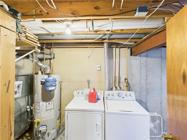 clothes washing area with gas water heater and washer and dryer