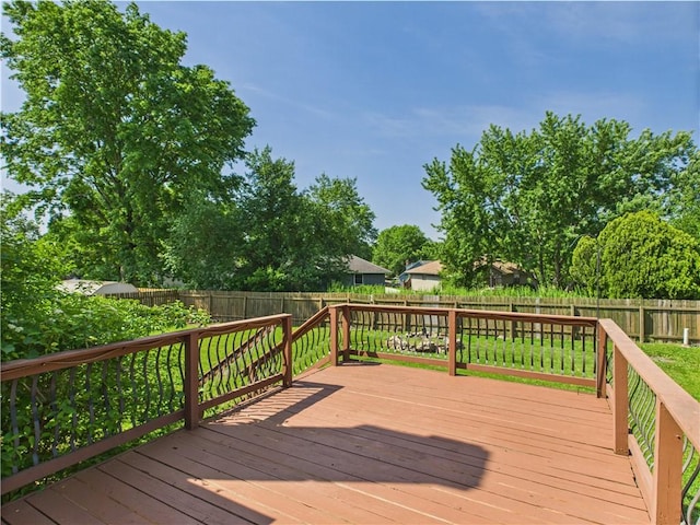 wooden deck featuring a fenced backyard