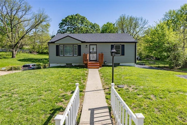 bungalow-style home featuring fence and a front yard