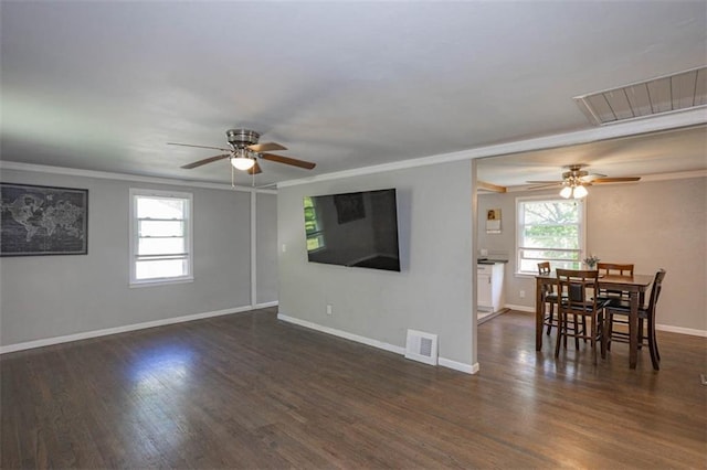 living room featuring ceiling fan, ornamental molding, baseboards, and visible vents
