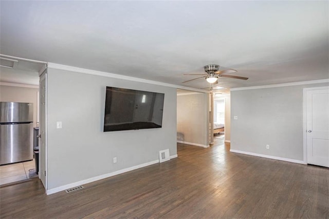 unfurnished living room with ornamental molding, baseboards, a ceiling fan, and visible vents