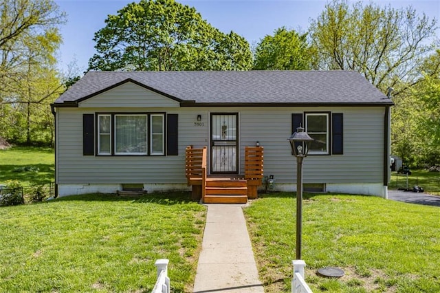 view of front of property with roof with shingles and a front lawn
