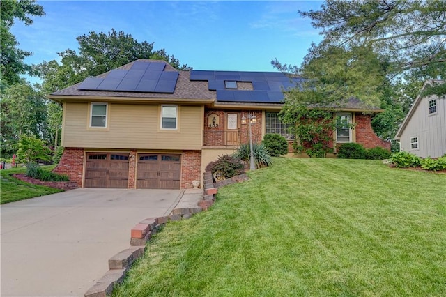 455 N Winnebago Dr, Lake Winnebago, MO 64034 - view of front of house with brick siding, an attached garage, a front yard, roof mounted solar panels, and driveway