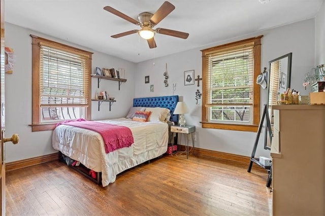 bedroom featuring wood-type flooring, baseboards, and ceiling fan