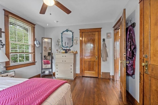 bedroom with wood finished floors, baseboards, and a ceiling fan