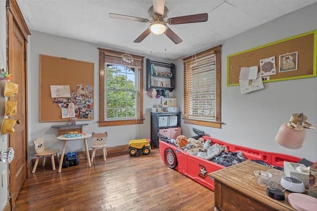 rec room featuring wood finished floors and ceiling fan