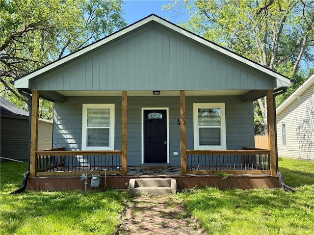 bungalow-style house featuring a porch and a front lawn