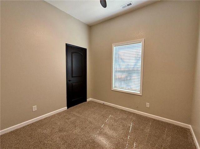 carpeted spare room with baseboards
